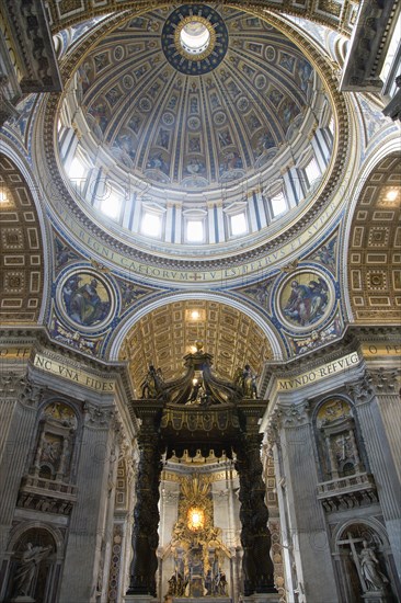 ITALY, Lazio, Rome, Vatican City The Dome of St Peter's designed by Michelangelo above the gilded bronze canopy of the Baldacchino by Bernini with his Throne of St Peter in Glory beyond
