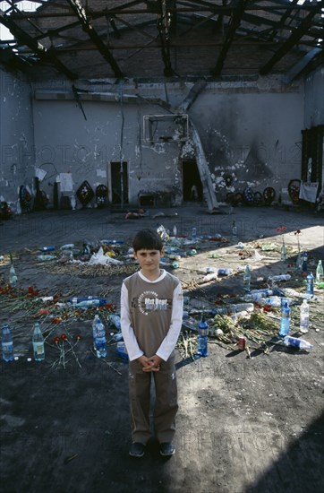 RUSSIA, South, Beslan, "Child standing in front of tributes left in school destroyed during 2004 siege by Chechen rebels in which hundreds died, the majority  children."