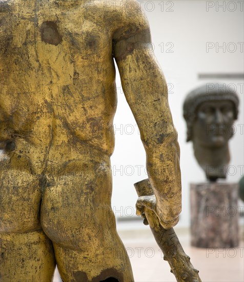 ITALY, Lazio, Rome, The Palazzo dei Conservatori part of the Capitoline Museum with the gilded bronze cult Statue of Hercules of The Forum Boarium in the foreground and the giant bronze head of Constantine beyond