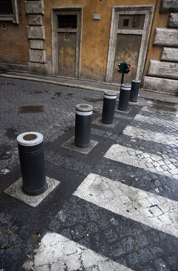 ITALY, Lazio, Rome, Automatic rising bollards and a pedestrian crossing in a side street with red and green traffic control lights