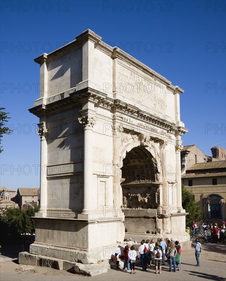 ITALY, Lazio, Rome, Tourists around the 19th Century reconstruction of the triumphal Arch of Titus in the Forum