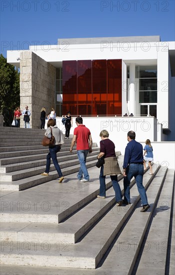 ITALY, Lazio, Rome, The steps with sightseers leading to the building hosuing the Ara Pacis or Altar of Peace built by Emperor Augustus to celebrate peace in the Mediteranean. The red prespex cube is part of a Valentino fashion exhibition at the museum