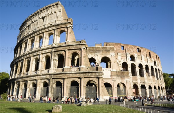 ITALY, Lazio, Rome, Tourists outside the Colosseum built by Emperor Vespasian in AD 69