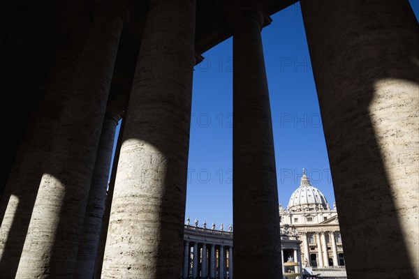ITALY, Lazio, Rome, Vatican City The facade of the Basilica of St Peter seen through the colonnade by Bernini