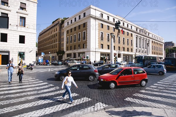 ITALY, Lazio, Rome, Pedestrian crossing with people and traffic on the Via della Conciliazione