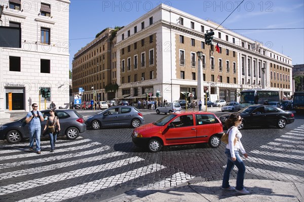 ITALY, Lazio, Rome, Pedestrian crossing with people and traffic on the Via della Conciliazione
