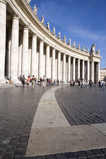 ITALY, Lazio, Rome, Vatican City Tourists in St Peter's Square beside the curving colonnade by Bernini