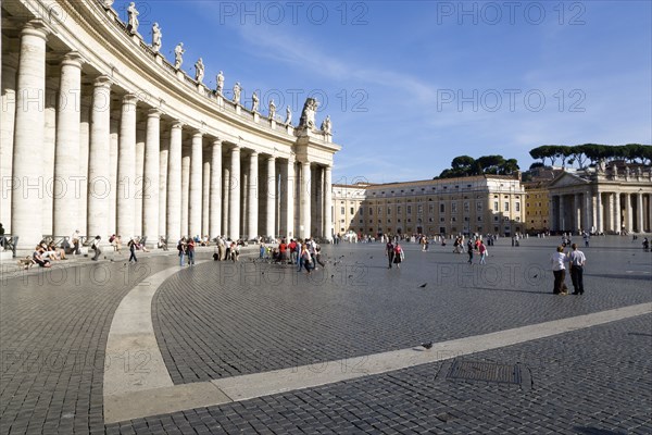 ITALY, Lazio, Rome, Vatican City Tourists in St Peter's Square beside the curving colonnade by Bernini