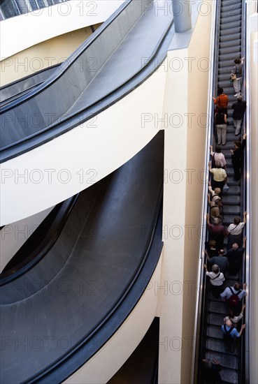 ITALY, Lazio, Rome, Vatican City Spiral ramp and escalator moving up with visitors at the entrance to the Museum