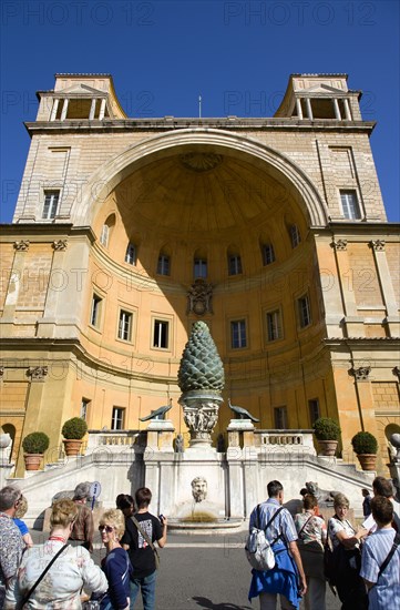 ITALY, Lazio, Rome, Vatican City Museum Tourists in the courtyard of the Belvedere Palace in front of the Cortile della Pigna a huge bronze pine cone from an ancient Roman fountain