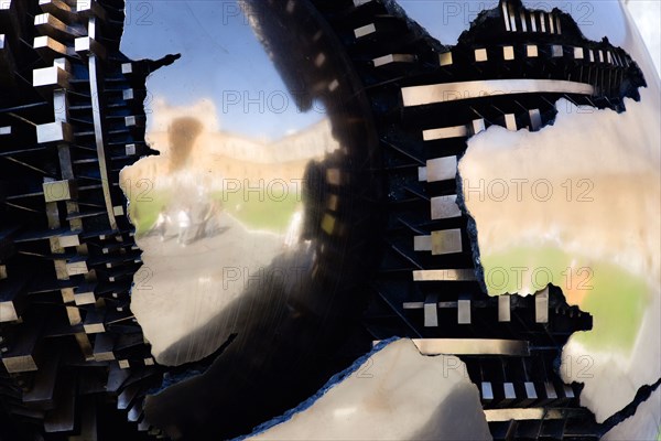 ITALY, Lazio, Rome, Vatican City Museum Detail of the sculpture Sphere Within Sphere by the Italian sculptor Arnaldo Pomodoro in the Cortile della Pigna with the Belvedere Palace reflected