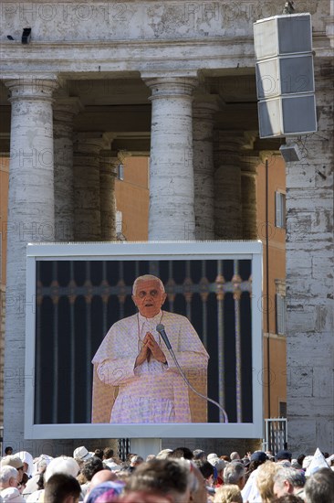 ITALY, Lazio, Rome, Vatican City Pilgrims in St Peter's Square for the wednesday Papal Audience in front of the Basilica watching Pope Benedict XVI Joseph Alois Radzinger with a cardinal on a large video TV monitor display