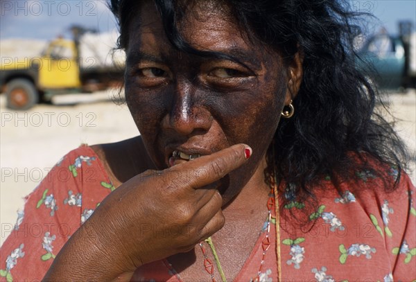 COLOMBIA, La Guajira, Manaure, Head and shoulders portrait of a woman cake seller eating a piece of cake at the Manaure Salt Mine which is worked by Guajiro / Wayu Indians