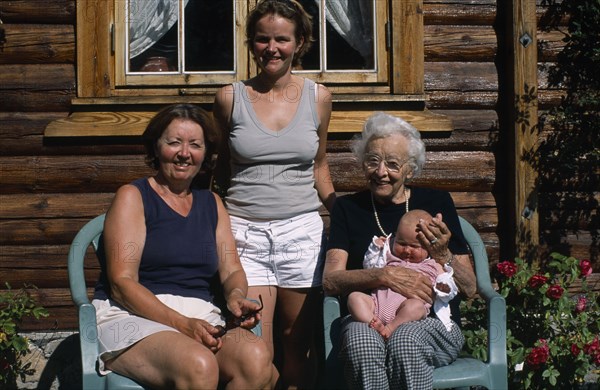 PEOPLE, Relationships, Generations, "Group portrait of four generations of the Fossgard family including mother, grandmother and great grandmother holding new baby in Norway"