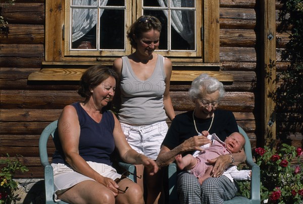PEOPLE, Relationships, Generations, "Group portrait of four generations of the Fossgard family including mother, grandmother and great grandmother holding new baby in Norway"