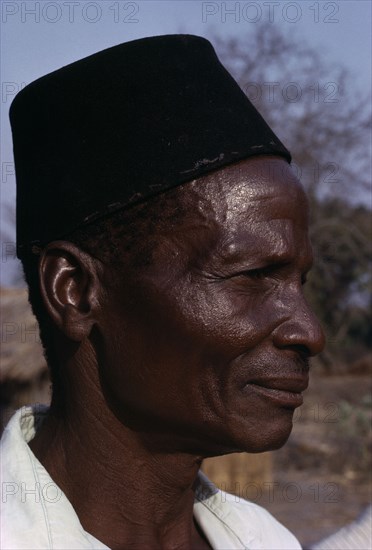 MALAWI, Tribal People, Yau Tribe, Head and shoulders portrait side profile of a man from the Yau tribe wearing a black hat