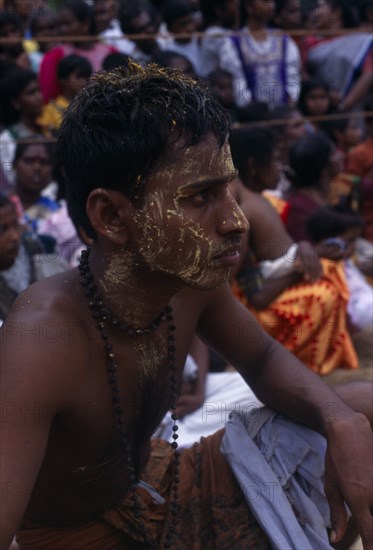 SRI LANKA, Religion, Hinduism, Punnaccolai Festival. Tamil Temple Guardian Sooriyakaran? (Shanthi’s brother?) with turmeric paste on head and face which has a cooling effect in preparation for a fire walk. Perfomed as part of a religious vow to honour Goddess Kali