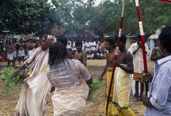 SRI LANKA, Religion, Hinduism, Punnaccolai Festival. Priest and woman in a state of trance watched by onlookers