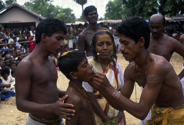 SRI LANKA, Religion, Hinduism, "Punnaccolai Festival. Tamil Oracle named Sothimalar with her son, both having ritual trident piercings inserted through cheeks"
