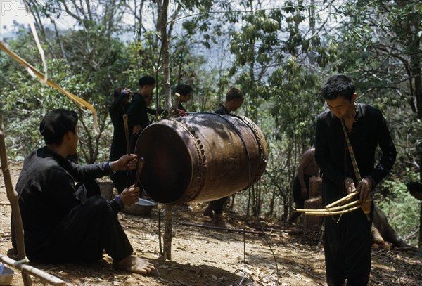 LAOS, Tribal People, Meo Tribe, Meo men playing musical instruments during the traditional ox killing ritual