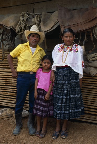 GUATEMALA, Tribal People, Q’eqchi, "Full lengh standing portrait of a Q’eqchi Indian family, a rich land owner with his wife and daughter"