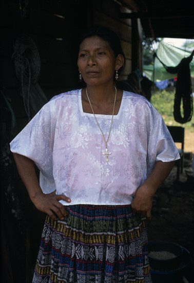 GUATEMALA, Alta Verapaz, Sacaak , Portrait of a Q’eqchi Indian mother wearing a white blouse and a gold crucifix necklace in a Sacaak refugee settlement