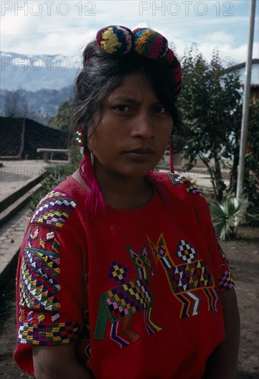 GUATEMALA, El Quiche, Chajul, Portrait of a Ixila Indian girl wearing a red huipile