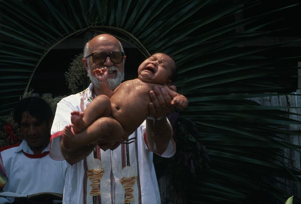 GUATEMALA, Alta Verapaz, Religion, Padre Tiziano an Italian Roman Catholic missionary baptising a Q’eqchi Indian baby