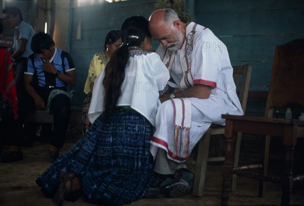GUATEMALA, Alta Verapaz, Religion, Padre Tiziano an Italian Roman Catholic missionary taking Confession with a Q’eqchi Indian girl