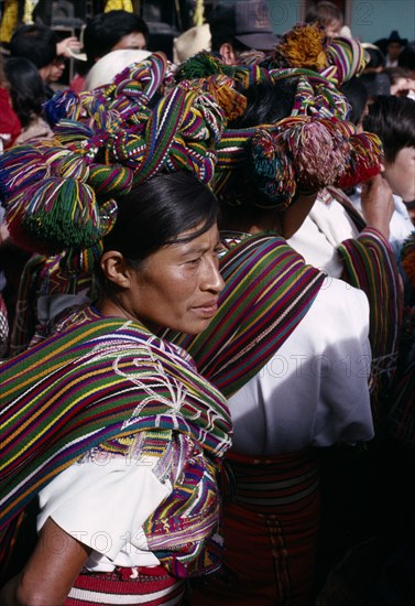 GUATEMALA, El Quiche, Nebaj, Ixil Indian women wearing traditional dress with an elaborate head-dress wrapped into the hair