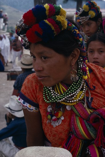 GUATEMALA, El Quiche, San Andres de Sacabaja, Quiche Indian woman wearing traditional colourful dress with beaded necklaces and elaborate head-dress at the San Andres festival