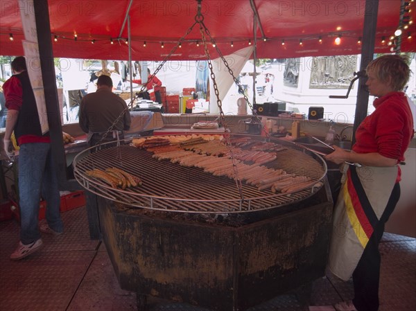 IRELAND, North, Belfast, German sausage vendor at international food festival outside the City Hall.
