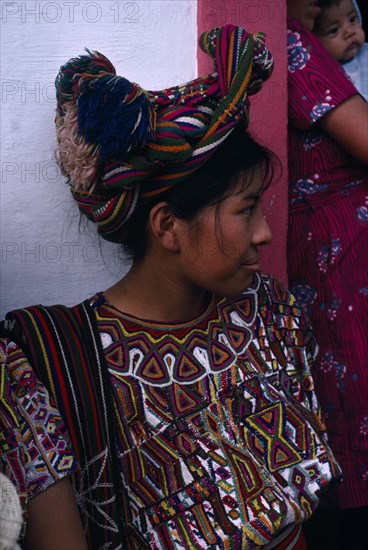GUATEMALA, El Quiche, Nebaj, Ixil Indian girl wearing traditional dress and an elaborate head-dress wrapped into the hair
