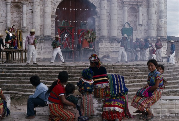 GUATEMALA, El Quiche, San Andres de Sajcabaja, Quiche Indians watching fireworks in front of the 16th century church during San Andres Festival on December 8th