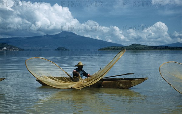 MEXICO, Michoacan, Patzcuaro, Fishermen butterfly net fishing from canoes on Lake Patzcuaro