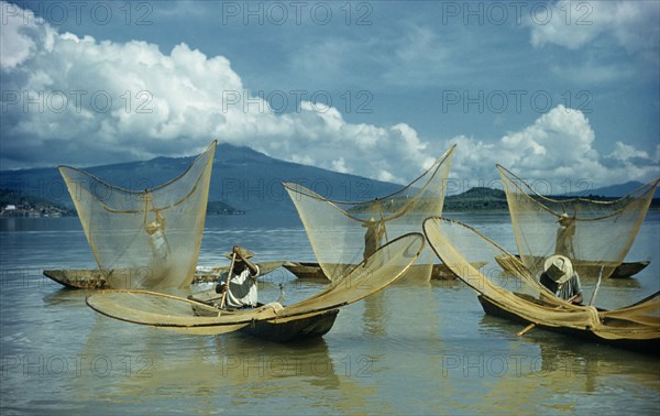 MEXICO, Michoacan, Patzcuaro, Fishermen butterfly net fishing from canoes on Lake Patzcuaro