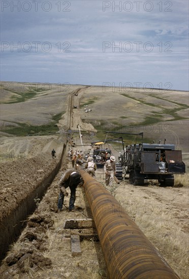 CANADA, Saskatchewan , Prairies, Constructing Trans Canada gas pipeline over Saskatchewan Prairies.