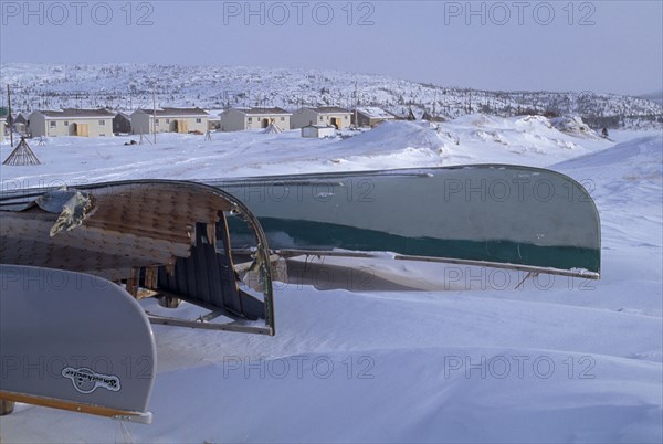 CANADA, Quebec, Hudson Bay, The Great Whale River Estuary in February with upturned canoes in deep snow for sealing and fishing in summer months. Cree indigeous community