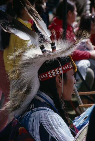 CANADA, Alberta, Edmonton, Blackfoot Native American Indian child wearing tribal dress with other plains Indians at Pow Wow