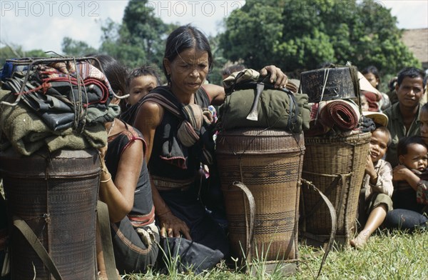 VIETNAM, Central Highlands, Kontum, Vietnam War. Montagnard refugee families waiting to be shipped back to their villages outside the battle zone.20092421