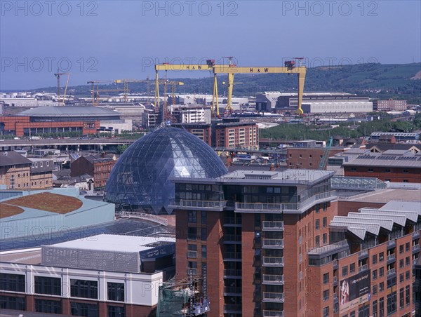 IRELAND, North, Belfast, Cityscape with Victoria Square shopping centre dome and cranes seen from The Belfast Wheel at City Hall.