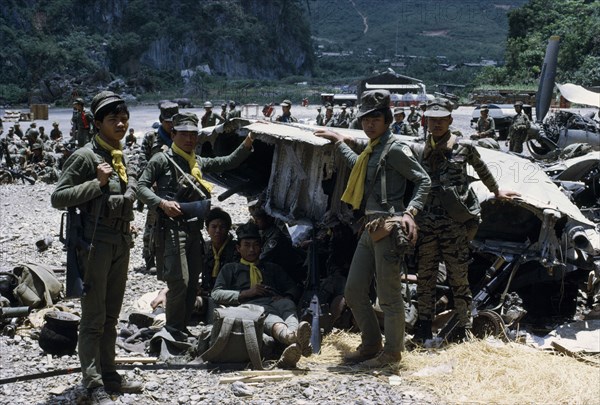 LAOS, Xiangkhoang, ??? , "Meo soldiers gathered around an American plane shot down over Pathet Lao territory, now in secret CIA base of ??? carrying armour and wearing uniform with yellow scarves before returning to battle front"