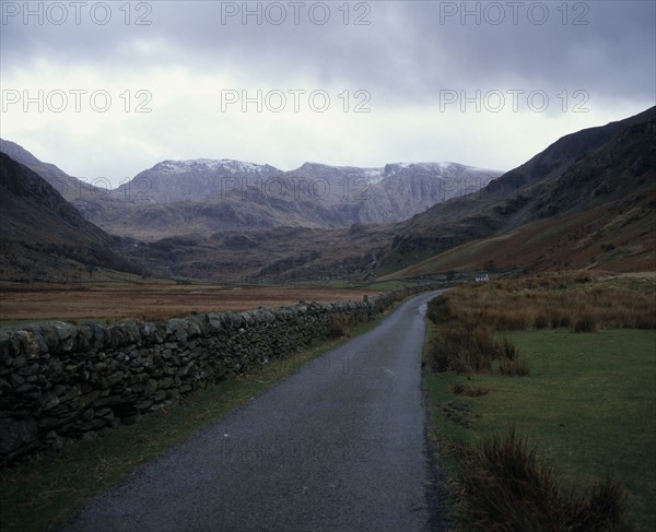 WALES, Gwynedd, Snowdonia , View south along Nant Francon Valley from the old road towards Snowdonia seen with a light snow cover. Skyline ridge left to right Tryfan mountain 917metres (3004 feet) Glyders mountain 996metres (3262 feet)