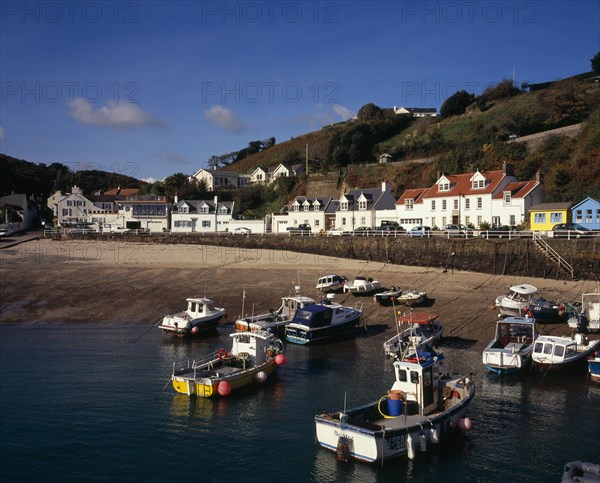 UNITED KINGDOM, Channel Islands, Jersey, "St Martins. Rozel fishing village on the north coast. View from the jetty towards fishing boats, sandy beach and waterfront houses "
