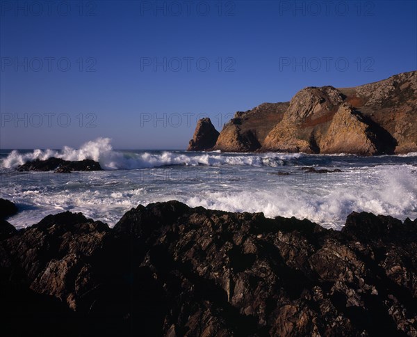 UNITED KINGDOM, Channel Islands, Jersey, St Ouen. Le Pulec. Rough sea with waves crashing against rocky foreshore