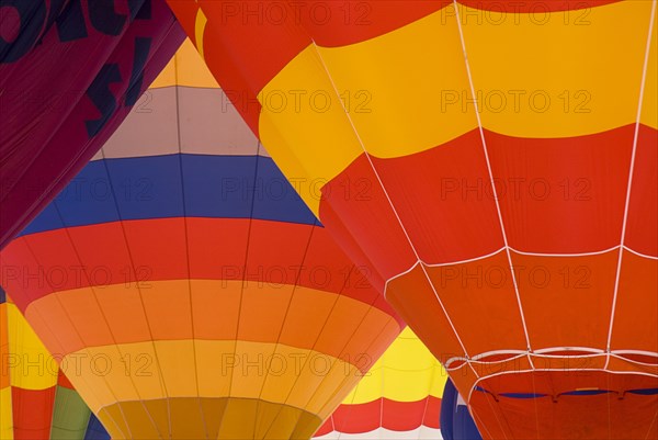 SWITZERLAND, Canton de Vaud, Chateau d'Oex, Patterns of a number of inflated Hot Air Balloons close together.