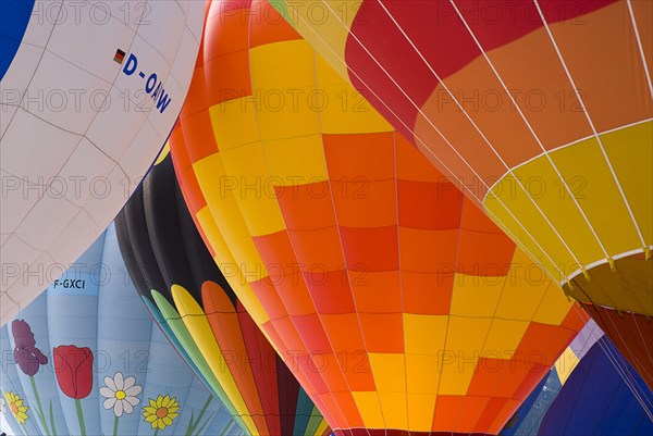 SWITZERLAND, Canton de Vaud, Chateau d'Oex, Inflated Hot Air Balloons with prominent flower pattern on one.
