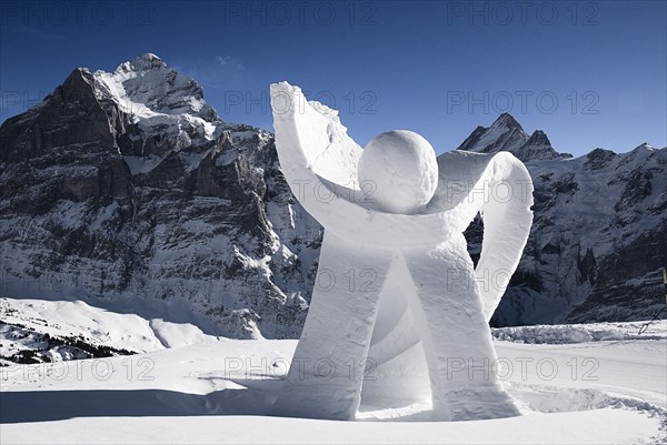 SWITZERLAND, Bernese Oberland, Grindelwald, Ice sculpture at Grindelwald First summit station with Eiger mountain behind.