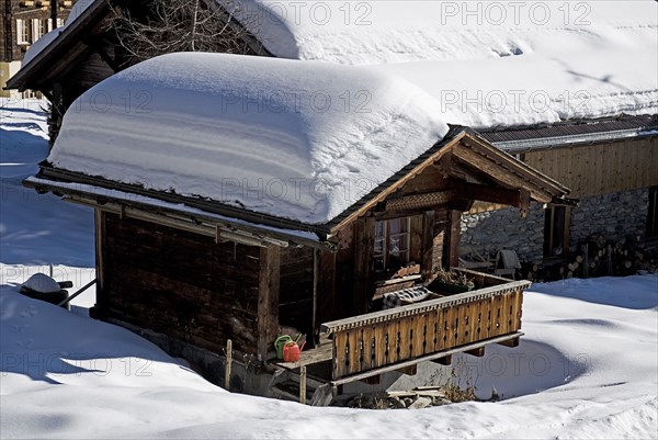 SWITZERLAND, Bernese Oberland, Murren, Snow covered house in the centre of Murren town.