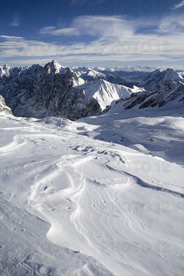 GERMANY, Bavaria, Zugspitze, Vista south from Zugspitzplatt with dramatic sky.